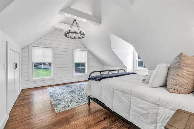 a bedroom with a bed and window