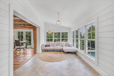 a living room with furniture and large windows