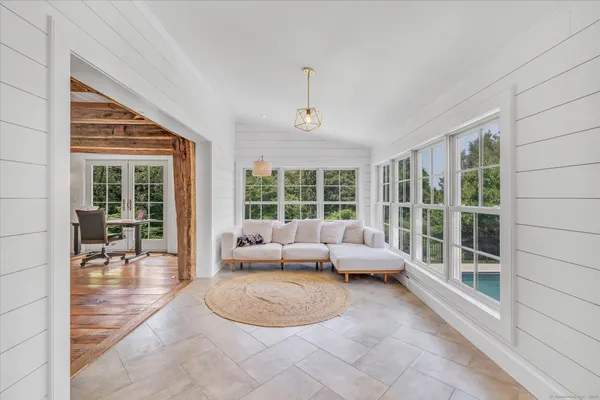 a living room with furniture and large windows