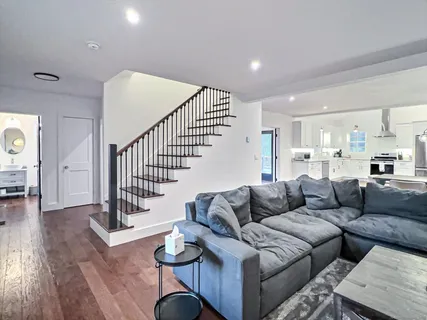 a living room with furniture and wooden floor