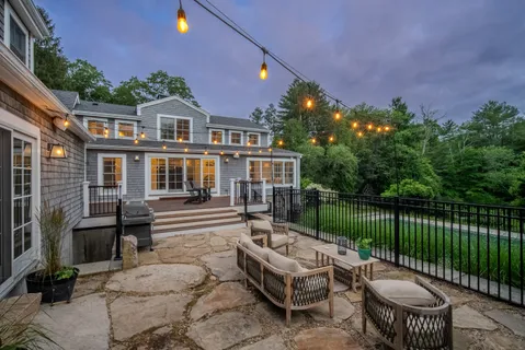 a view of a patio with couches table and chairs and potted plants