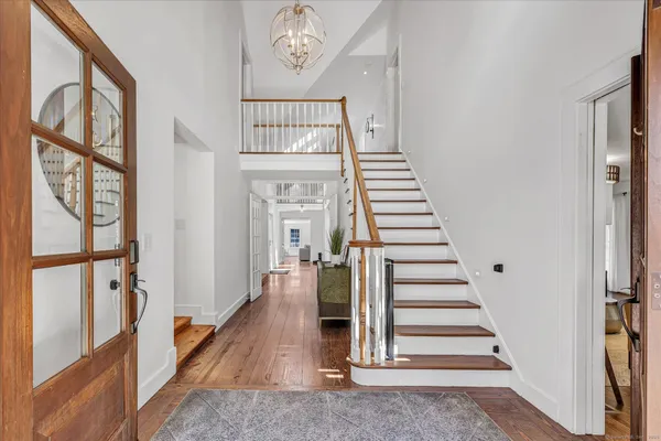 a view of entryway and hall with wooden floor