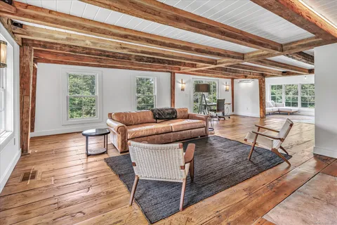 a living room with furniture and a floor to ceiling window