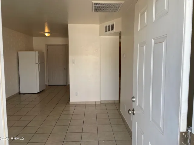 a view of a livingroom with an empty space and a hallway