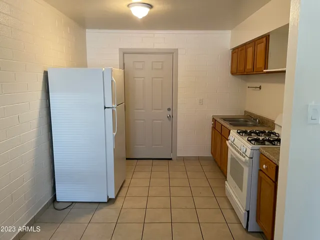 a kitchen with a refrigerator and a stove