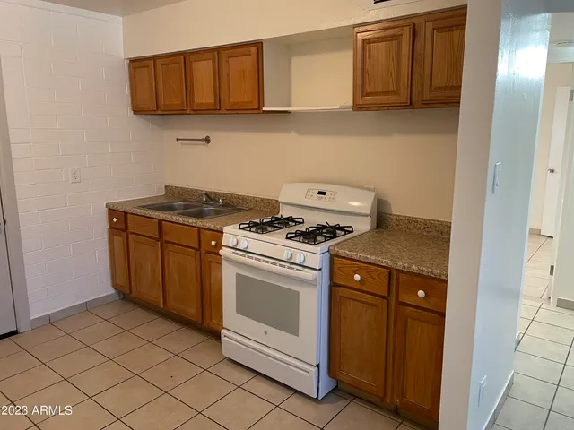 a kitchen with granite countertop cabinets and steel stainless steel appliances