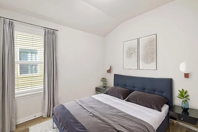 a bedroom with a bed and a window