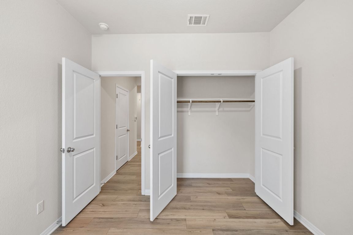 700 Autumn Stem Place Austin, TX 78748 - Photo 16 of 36 a view of a hallway with wooden floor