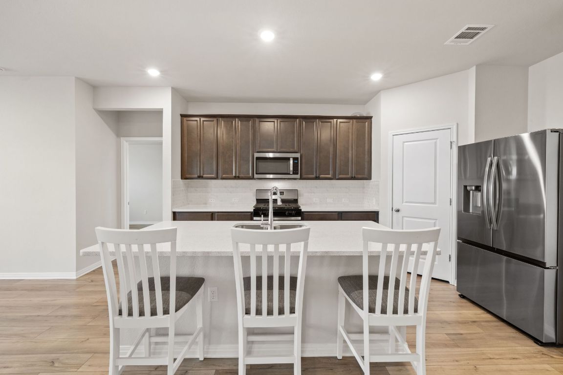700 Autumn Stem Place Austin, TX 78748 - Photo 17 of 36 a kitchen with stainless steel appliances granite countertop a refrigerator and a stove top oven