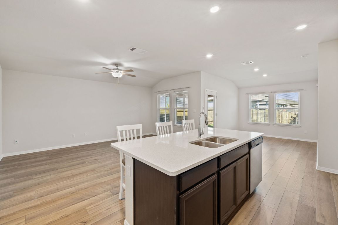 700 Autumn Stem Place Austin, TX 78748 - Photo 35 of 36 a kitchen with a sink cabinets and wooden floor