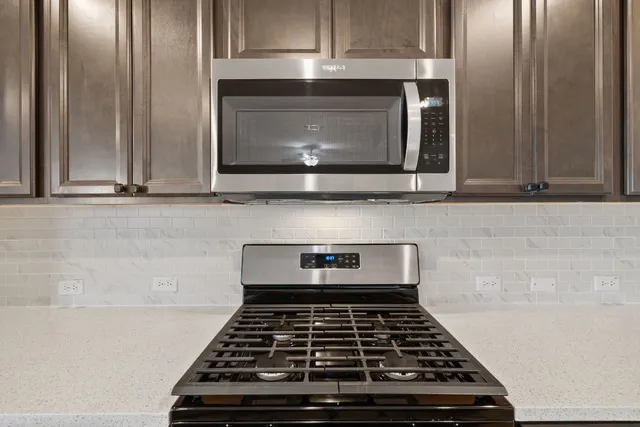 a kitchen with a sink cabinets and wooden floor