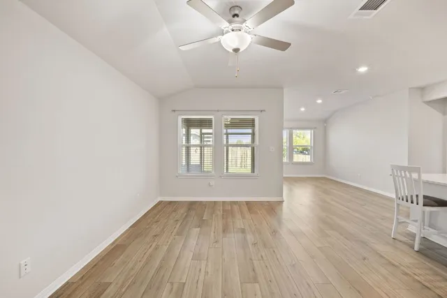 a living room with furniture and kitchen view