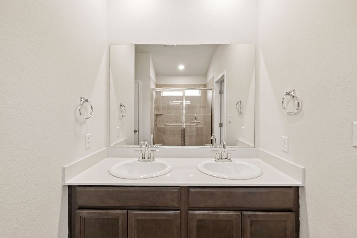 700 Autumn Stem Place Austin, TX 78748 - Photo 30 of 36 a bathroom with a sink and a mirror