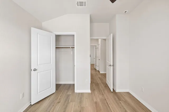 a view of hallway with wooden floor