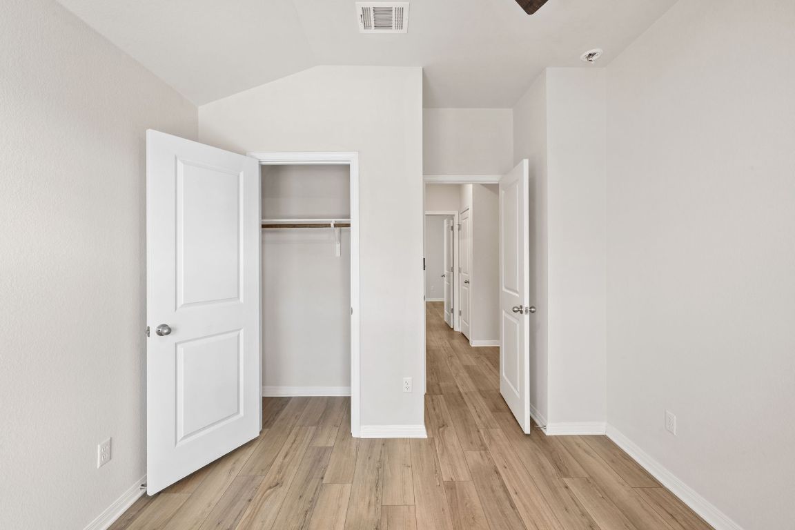 700 Autumn Stem Place Austin, TX 78748 - Photo 8 of 36 a view of hallway with wooden floor