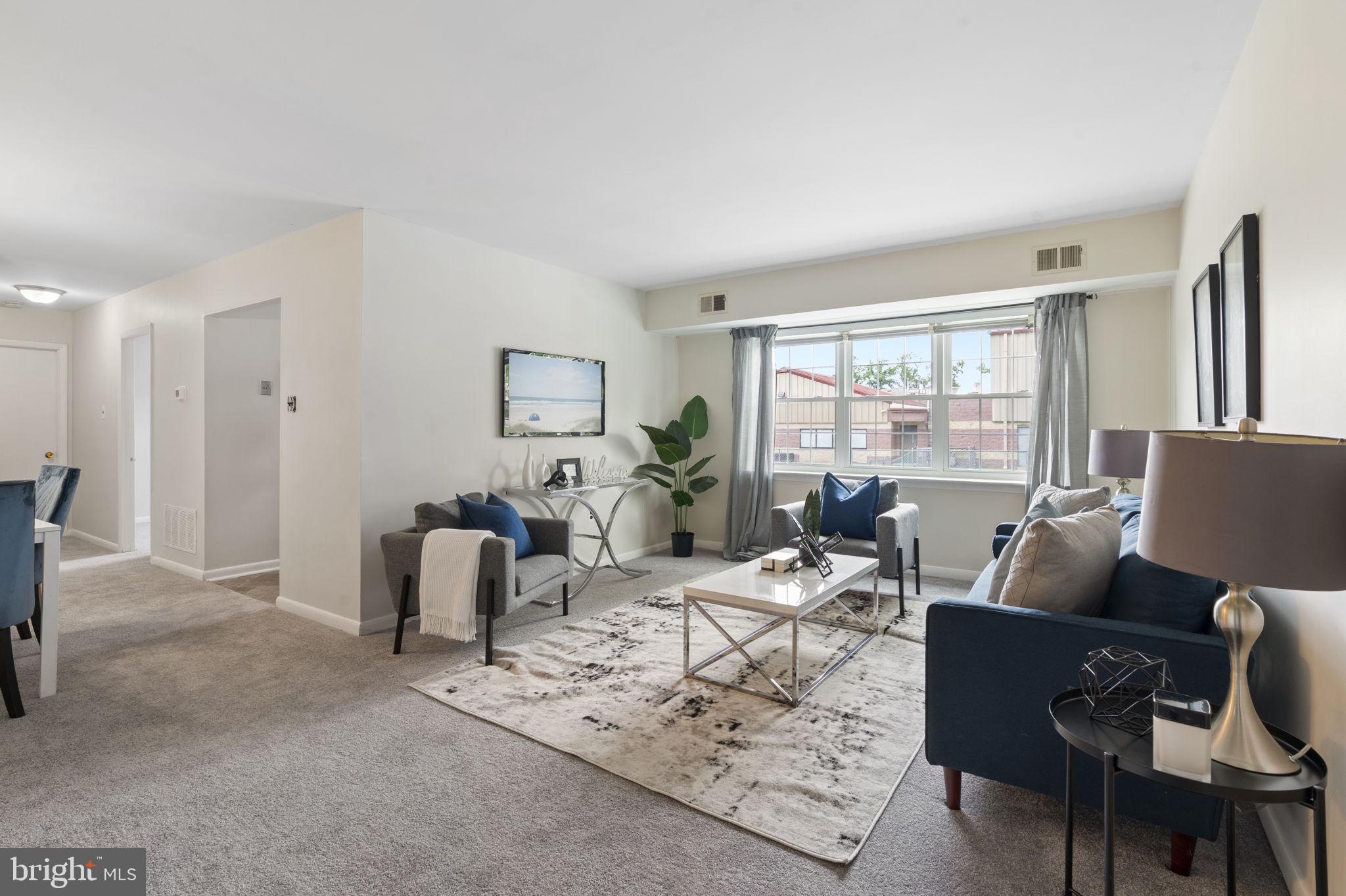 814 South Avenue, Unit J6 Secane, PA 19018 - Photo 2 of 15 a living room with furniture and a large window