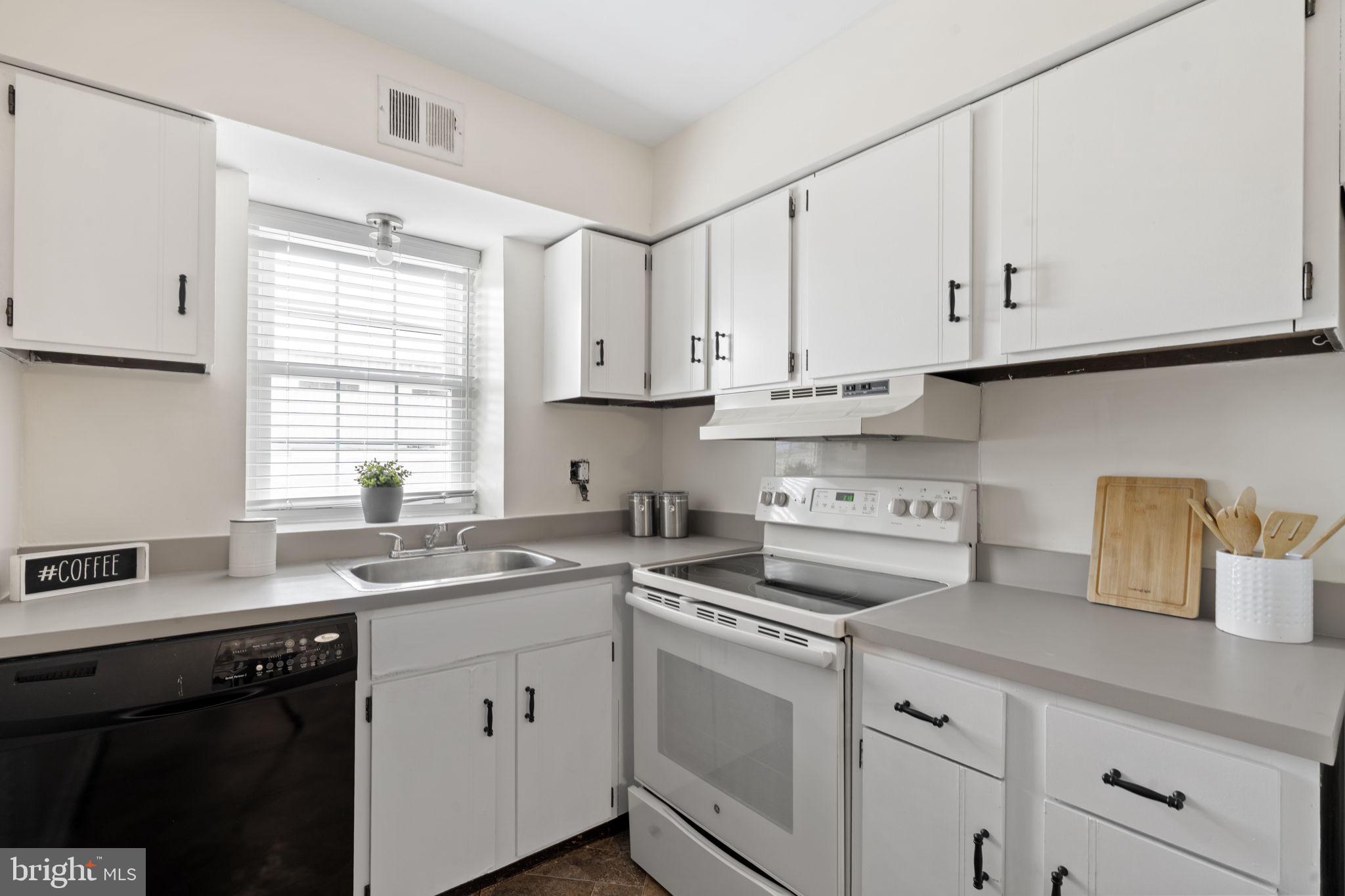814 South Avenue, Unit J6 Secane, PA 19018 - Photo 5 of 15 a kitchen with cabinets appliances a sink and a window