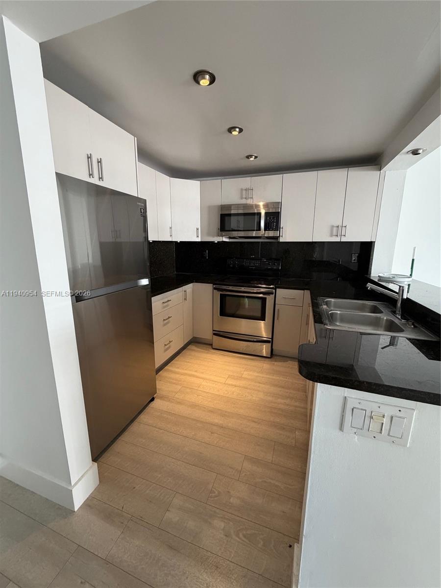 600 Northeast 36th Street, Unit 1205 Miami, FL 33137 - Photo 2 of 10 a kitchen with stainless steel appliances a refrigerator and a sink