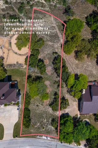 a view of a house with a big yard and large trees