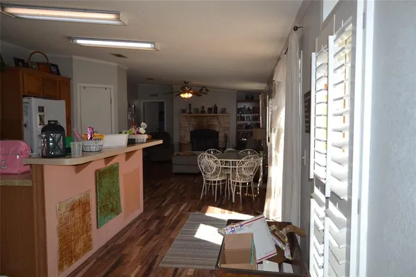 a dining room with furniture and a floor to ceiling window