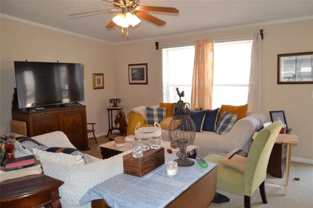 a white toilet sitting next to a bathroom sink vanity and a shower