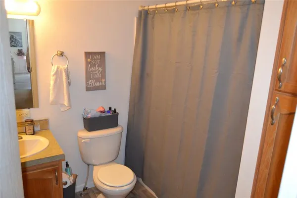 a bedroom with a bed and a wooden floor