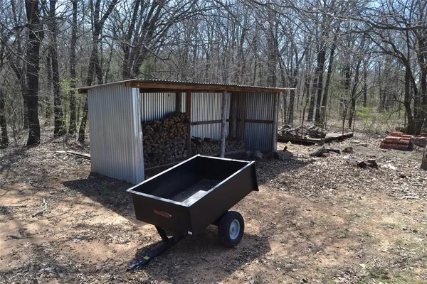 a backyard of a house with barbeque oven