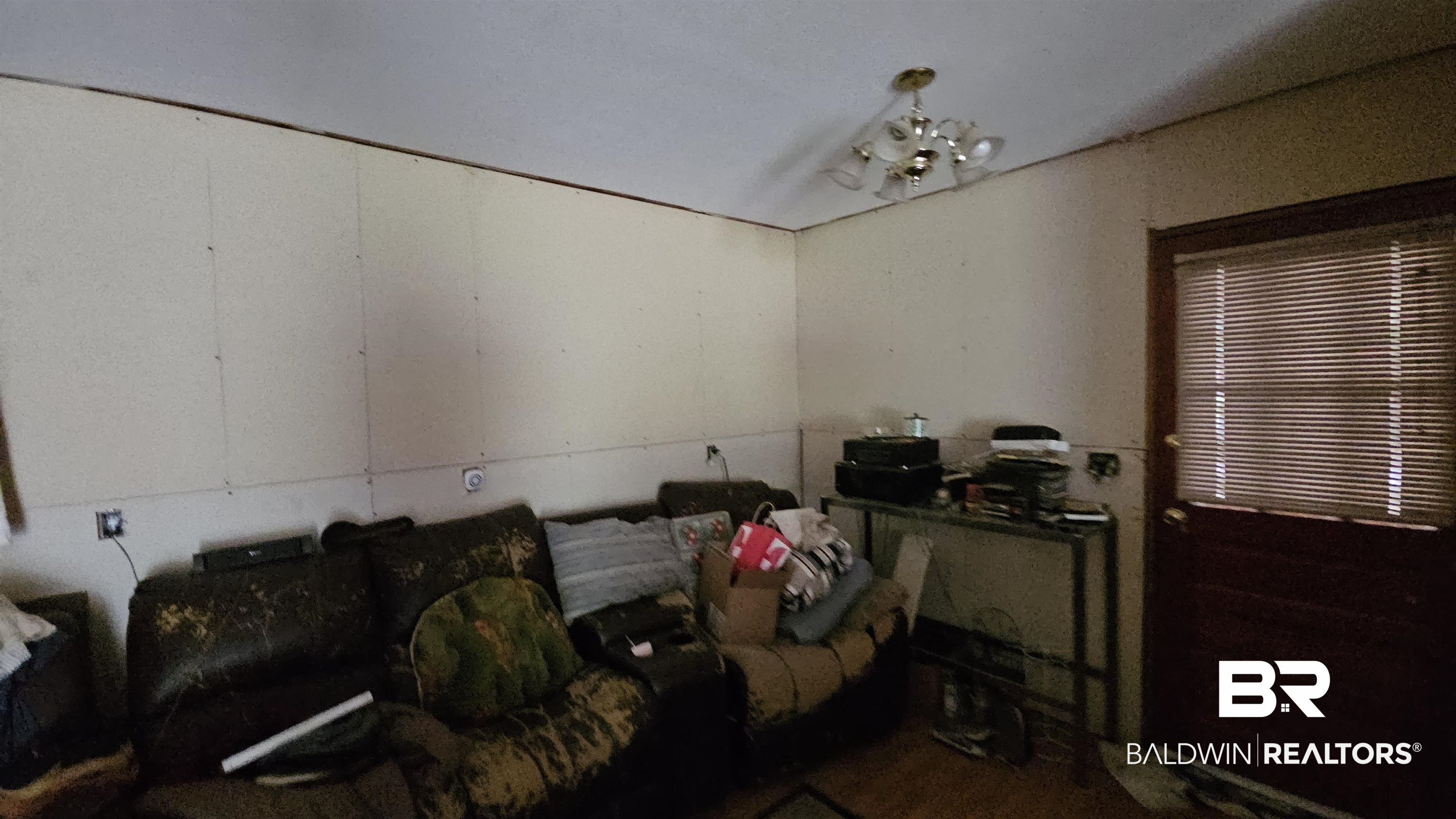 216 6th Avenue Atmore, AL 36502 - Photo 5 of 34 Living room featuring a notable chandelier