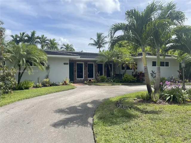 a front view of a house with a yard and a garage