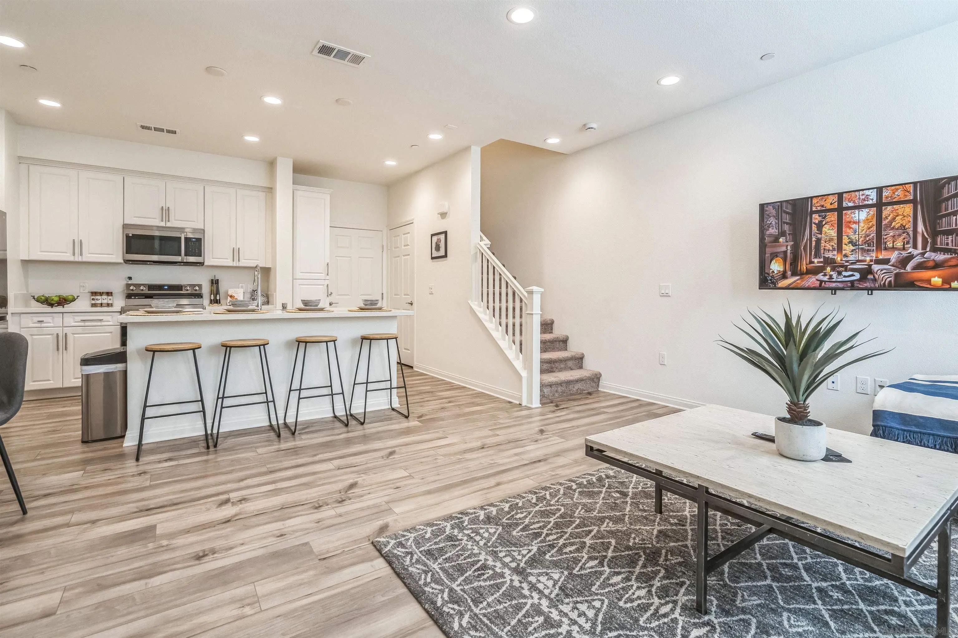 2018 Barite Street Spring Valley, CA 91977 - Photo 14 of 47 a living room with stainless steel appliances furniture wooden floor and a kitchen view