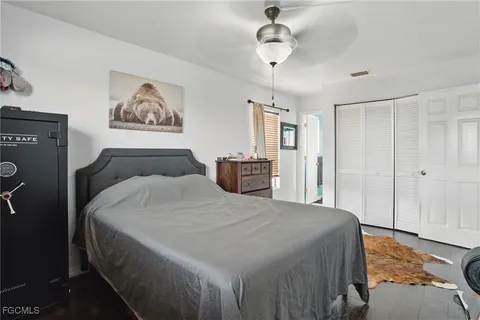 a bedroom with a large bed and a chandelier