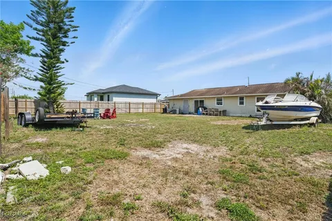 a house view with a swimming pool and garden