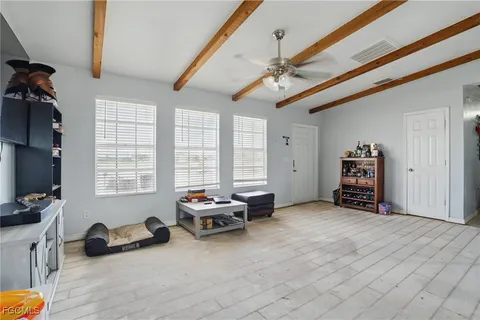 a bedroom with furniture and a large window