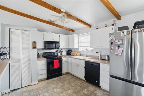 a kitchen with stainless steel appliances a refrigerator sink and stove