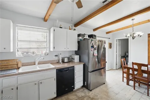 a kitchen with refrigerator and window