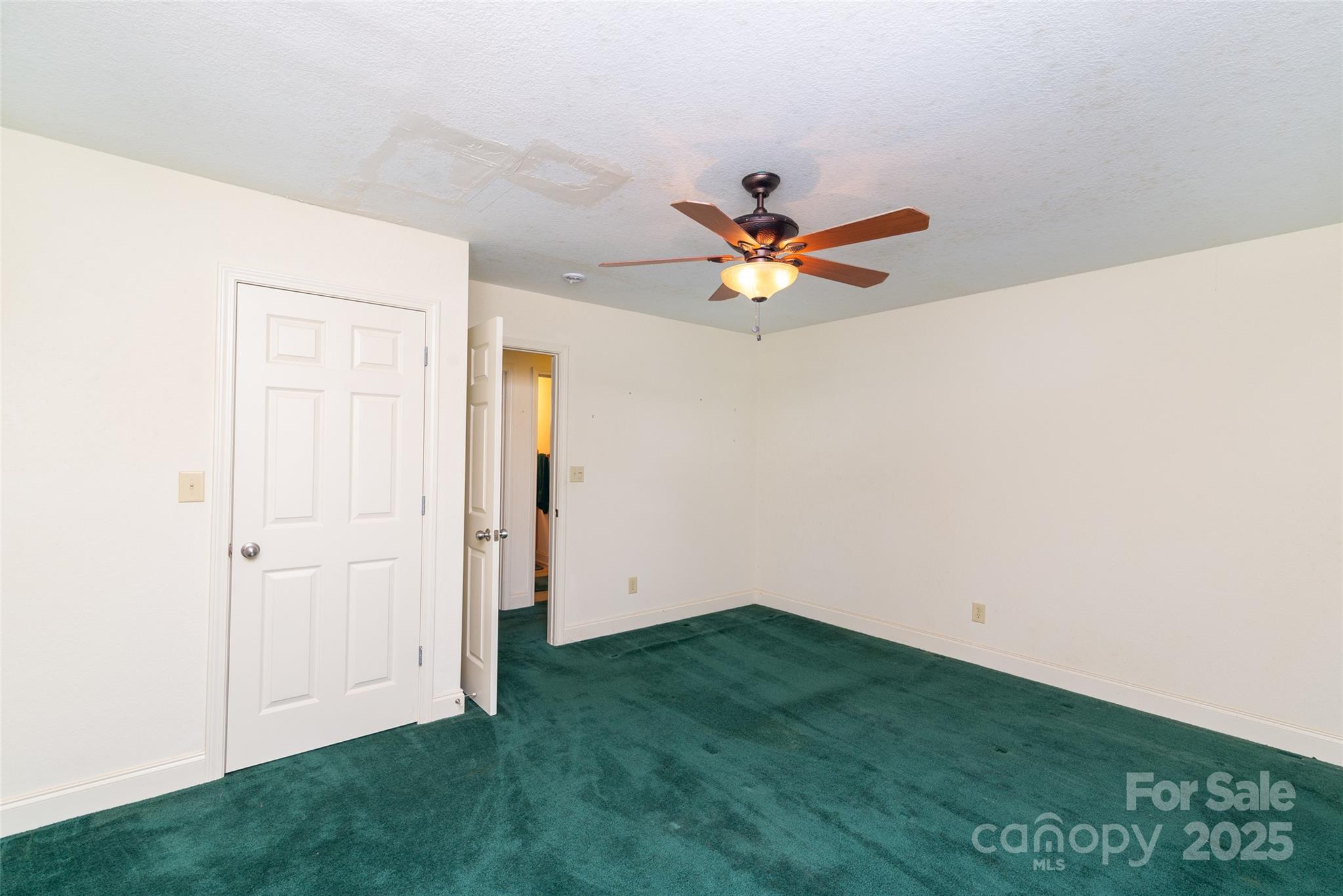 419 Bayberry Cove Road Sylva, NC 28779 - Photo 7 of 12 an empty room with a window and ceiling fan