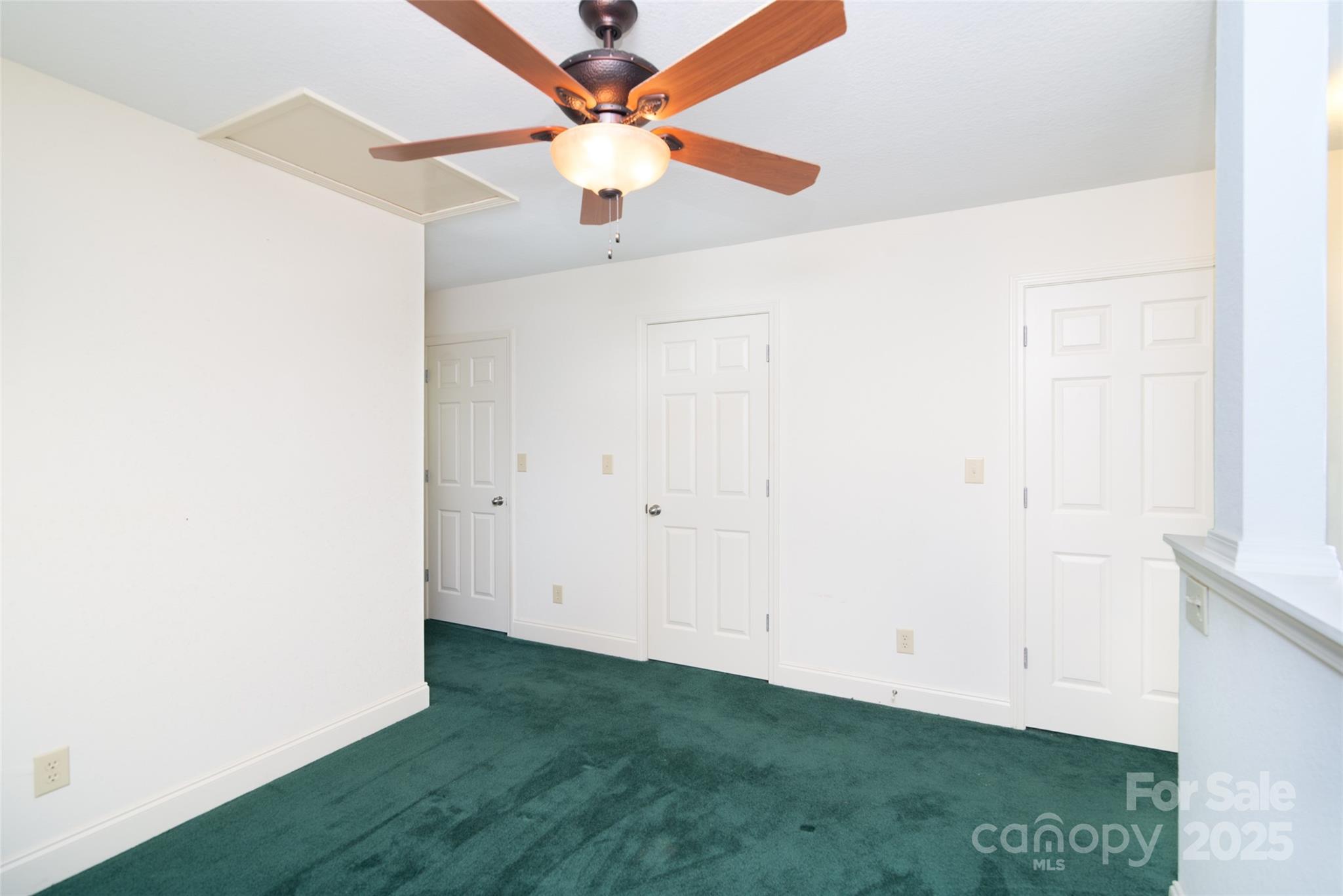 419 Bayberry Cove Road Sylva, NC 28779 - Photo 9 of 12 an empty room with a ceiling fan and a window