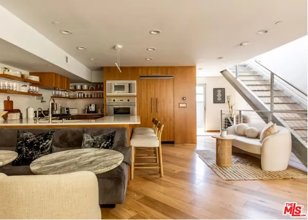 a kitchen with stainless steel appliances granite countertop a sink and a refrigerator