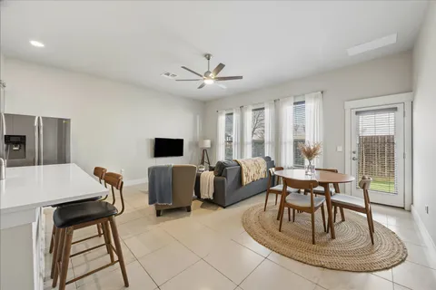 a living room with furniture a large window and a chandelier