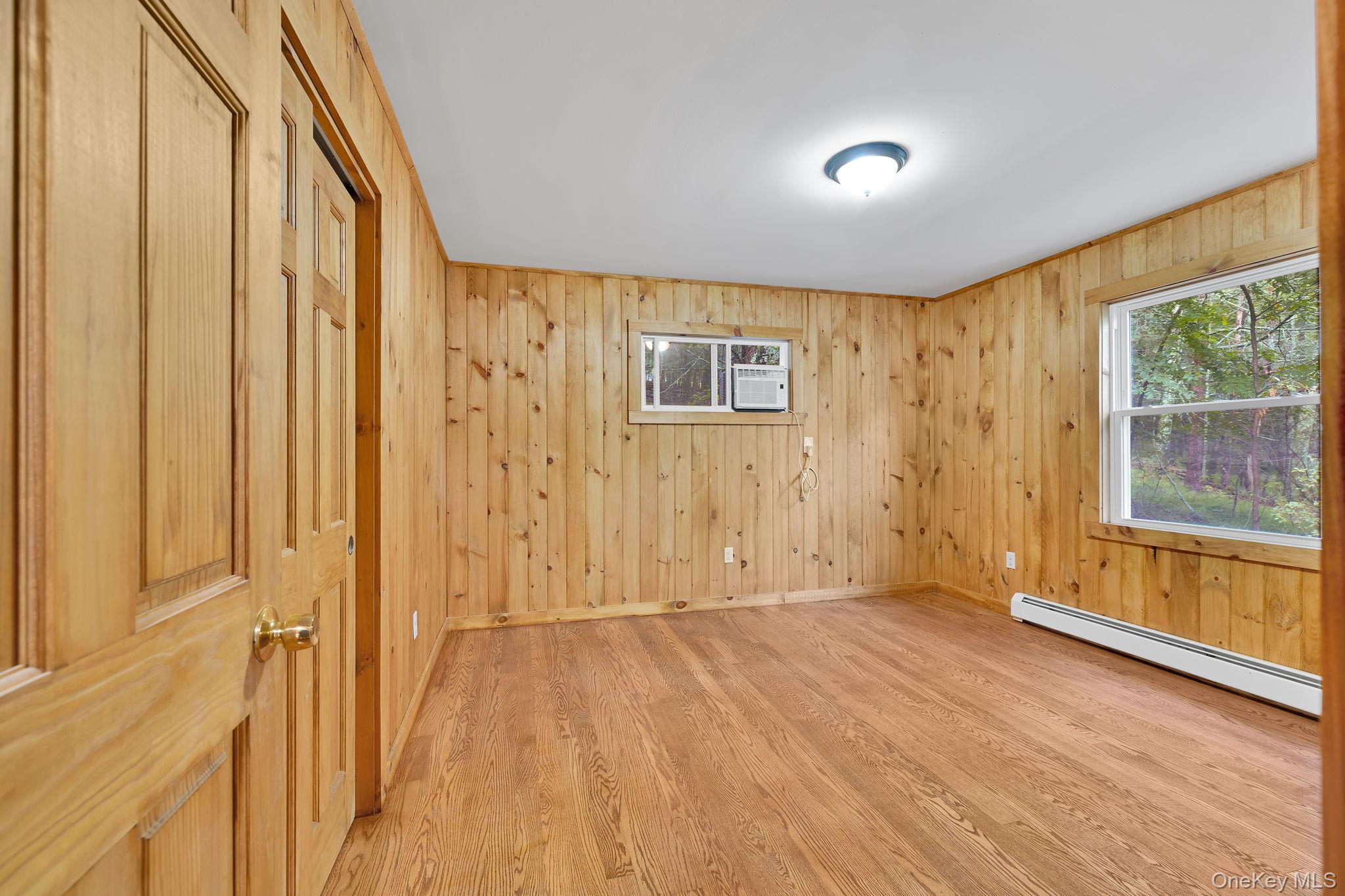 53 West Corbett Road Montgomery, NY 12549 - Photo 11 of 41 a view of an empty room with a window and wooden floor