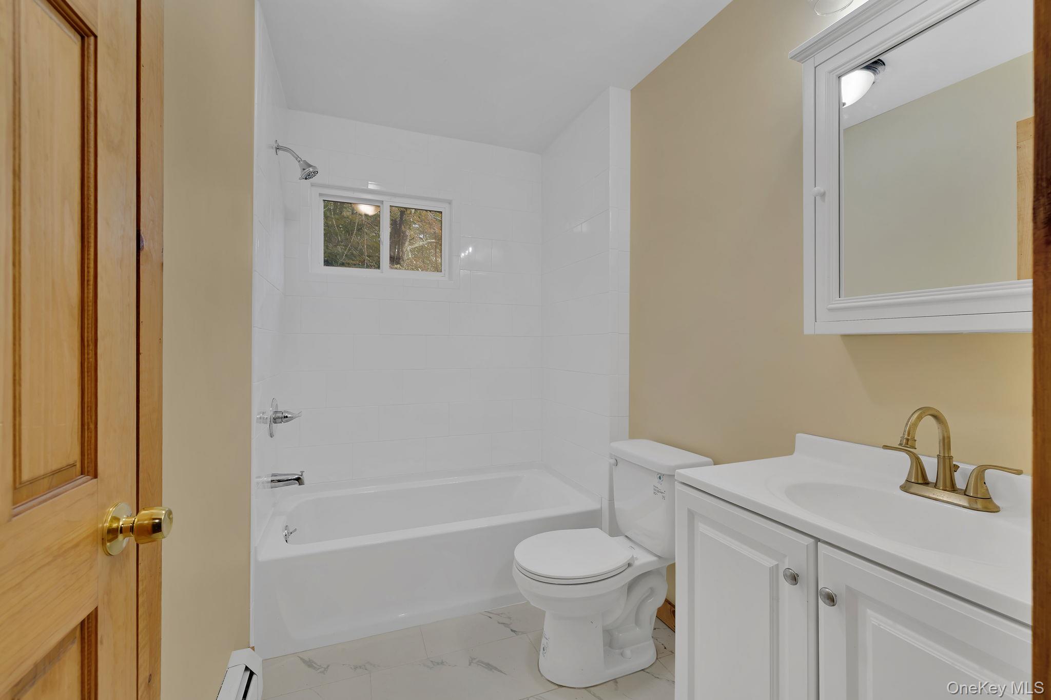 53 West Corbett Road Montgomery, NY 12549 - Photo 12 of 41 a bathroom with a toilet a sink a mirror and vanity