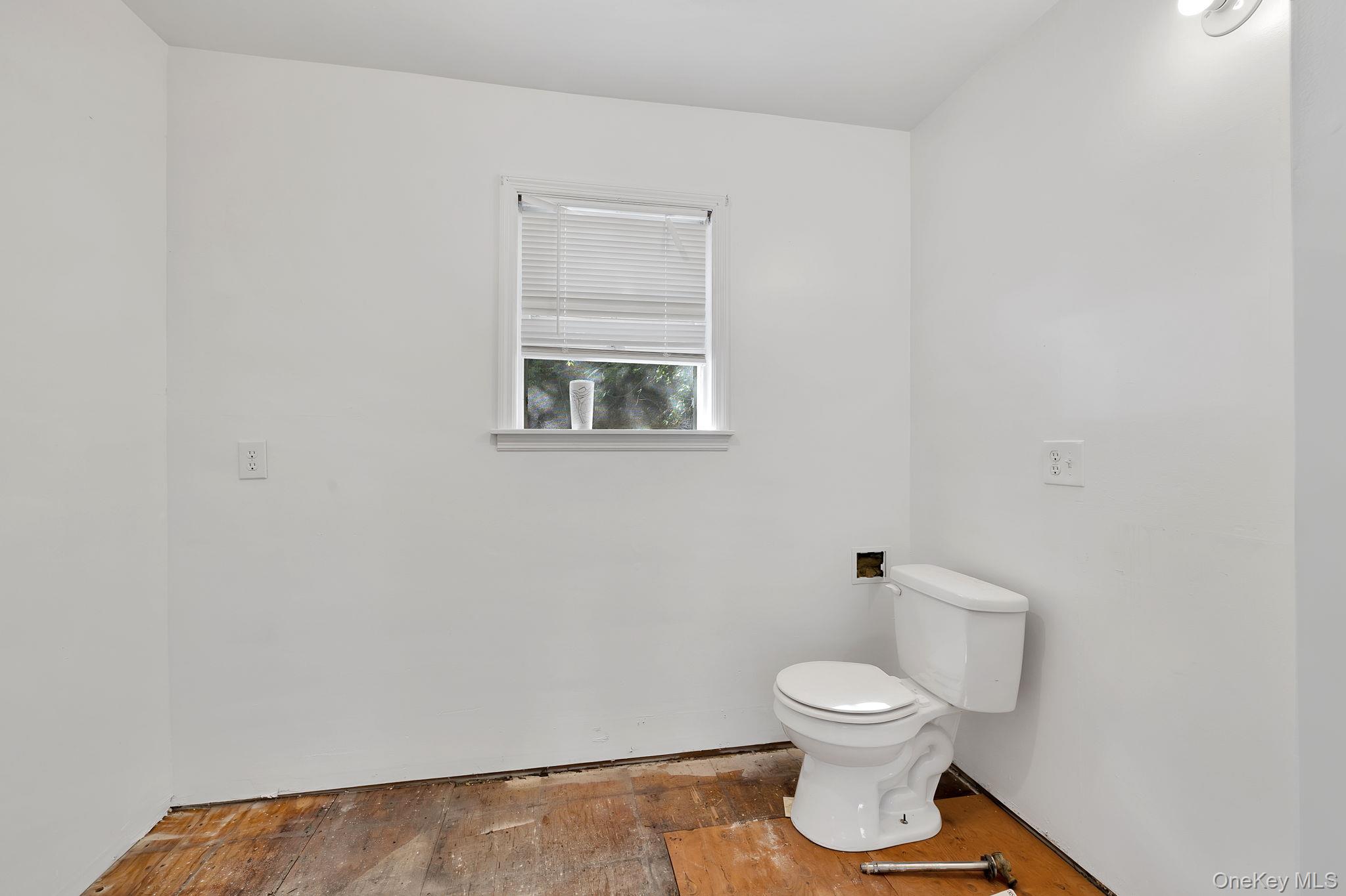 53 West Corbett Road Montgomery, NY 12549 - Photo 36 of 41 a bathroom with a toilet a sink and mirror