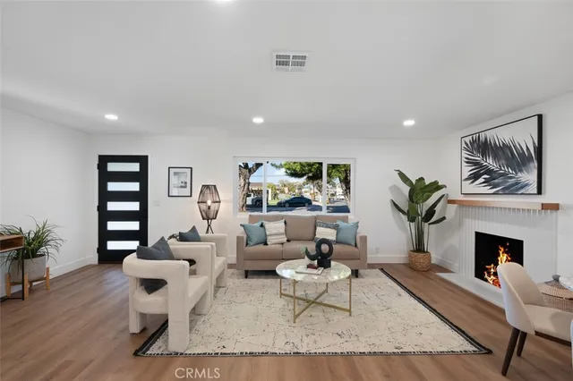 a living room with furniture a rug and a fireplace