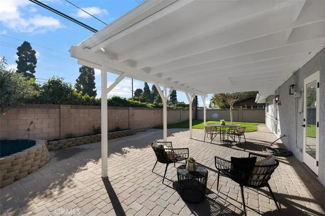 a view of a porch with furniture and backyard