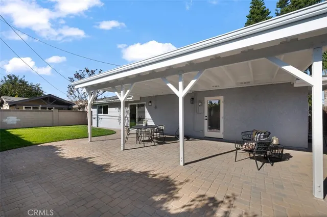 a view of a house with a yard and sitting area