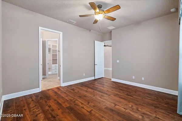 a view of an empty room and wooden floor