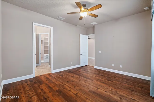 a view of an empty room and wooden floor