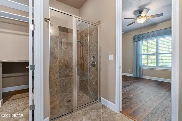 a view of a bathroom with a glass door shower