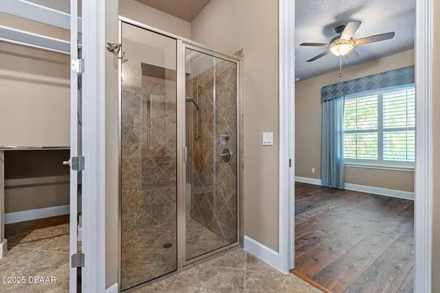 a view of a bathroom with a glass door shower