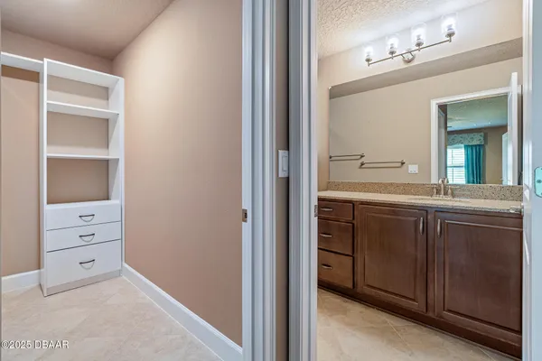 a en suite bathroom with a sink and a mirror